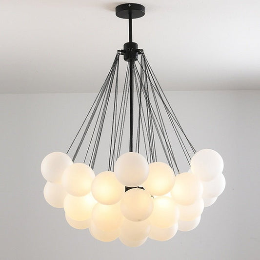Modern Nordic chandelier featuring a large cluster of milky white frosted glass balls with a black minimalist frame.