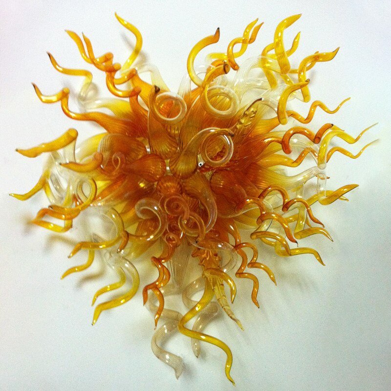 Elegant golden yellow artisan glass wall light with intricate, curly glass tendrils.