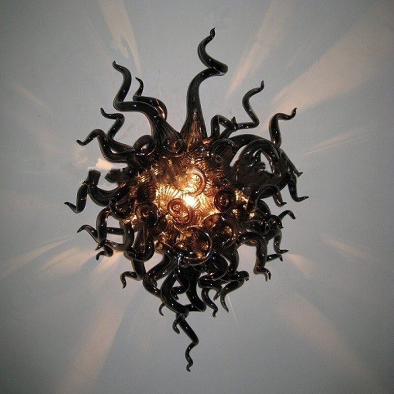 Sophisticated black swirl glass wall sconce for a bold, monochromatic design statement.