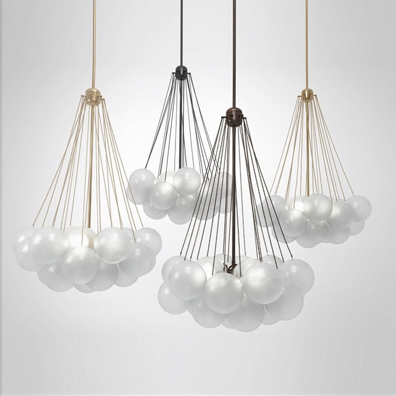Four frosted glass globe pendants in gold and black finishes showcasing different cluster sizes.