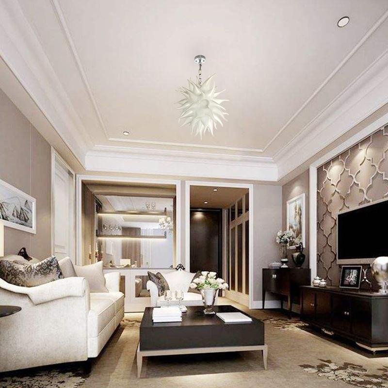 Luxury open-plan living room with white sofas and clean lines, showcasing the elegant silhouette of a frosted white art light.
