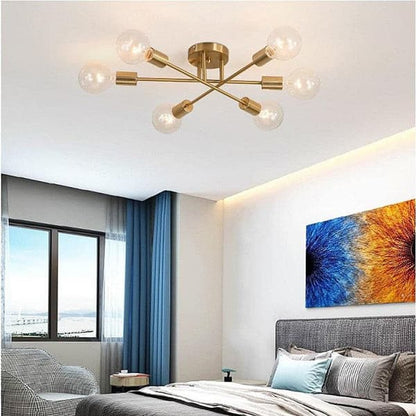 Industrial style linear gold chandelier featuring warm LED Edison bulbs for a cozy bedroom atmosphere.
