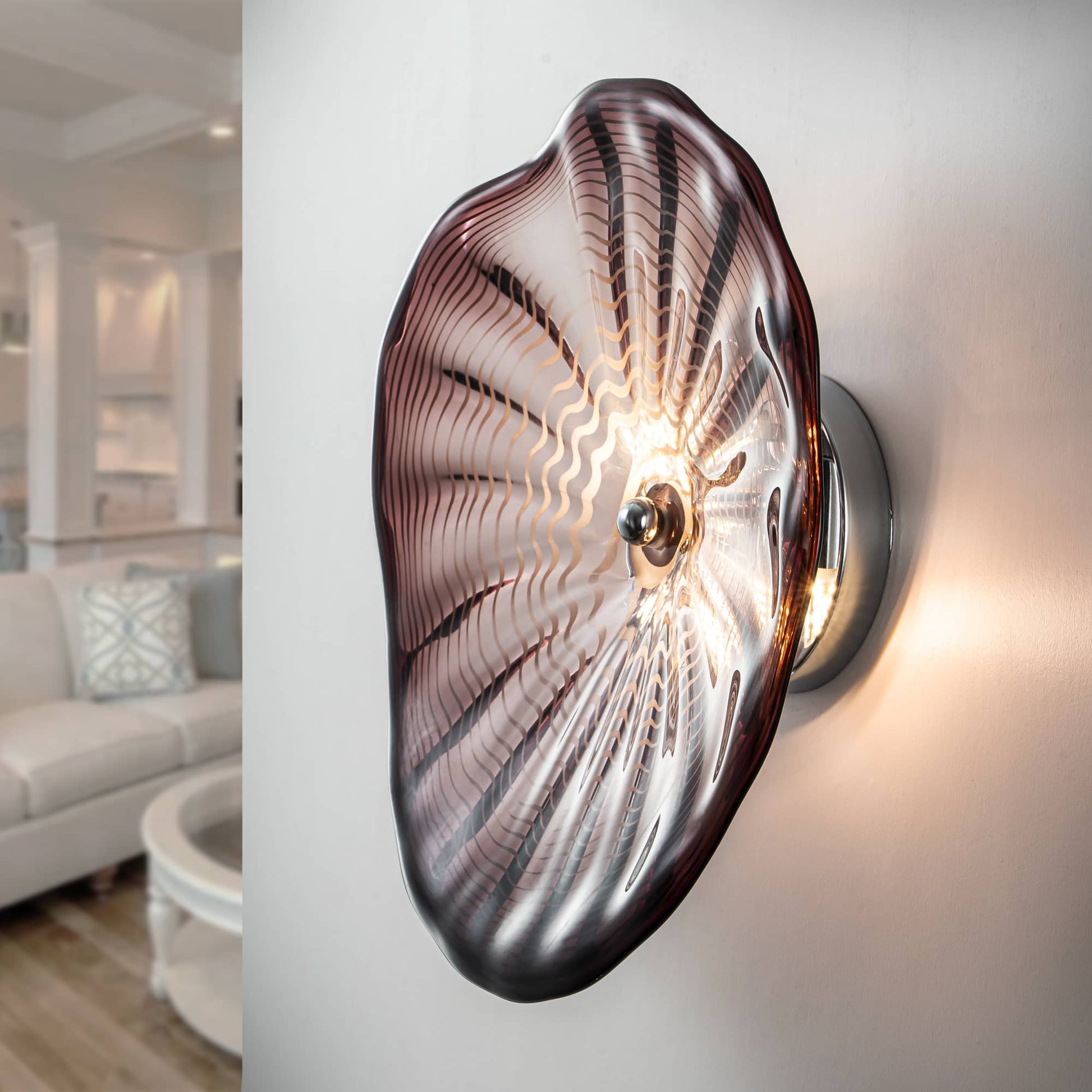 Elegant hand-blown glass wall flower light mounted on a modern living room wall.