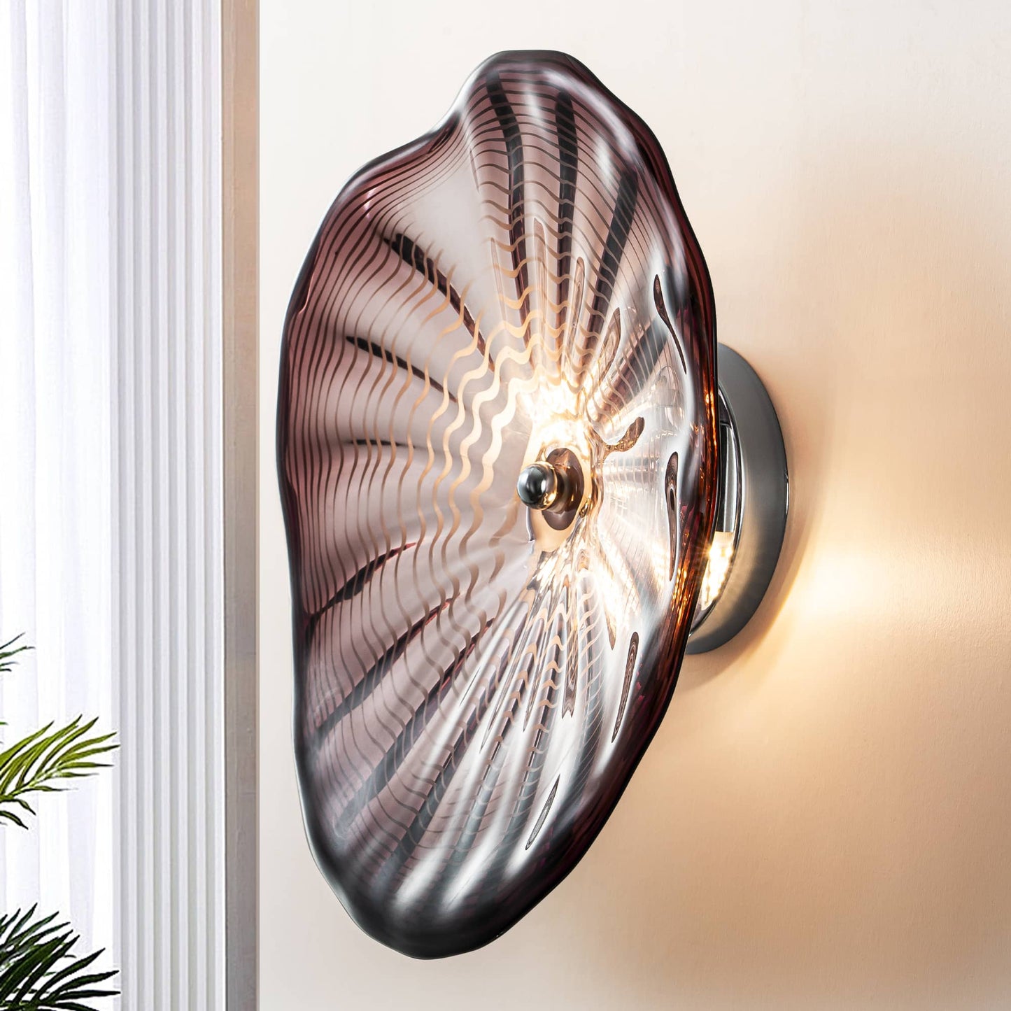 Side view of a brown Murano style glass wall sconce showing the metal mounting bracket and warm LED glow.