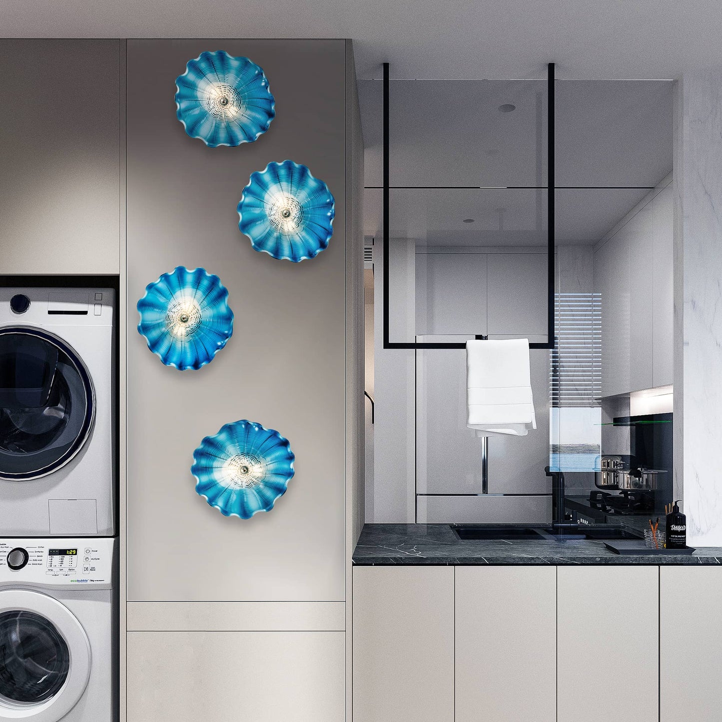 Vertical arrangement of five blue glass wall art plates in a modern laundry room setting.