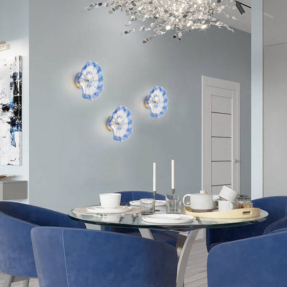 Modern dining room wall decor with a cluster of cobalt blue hand-blown glass flower sconces.