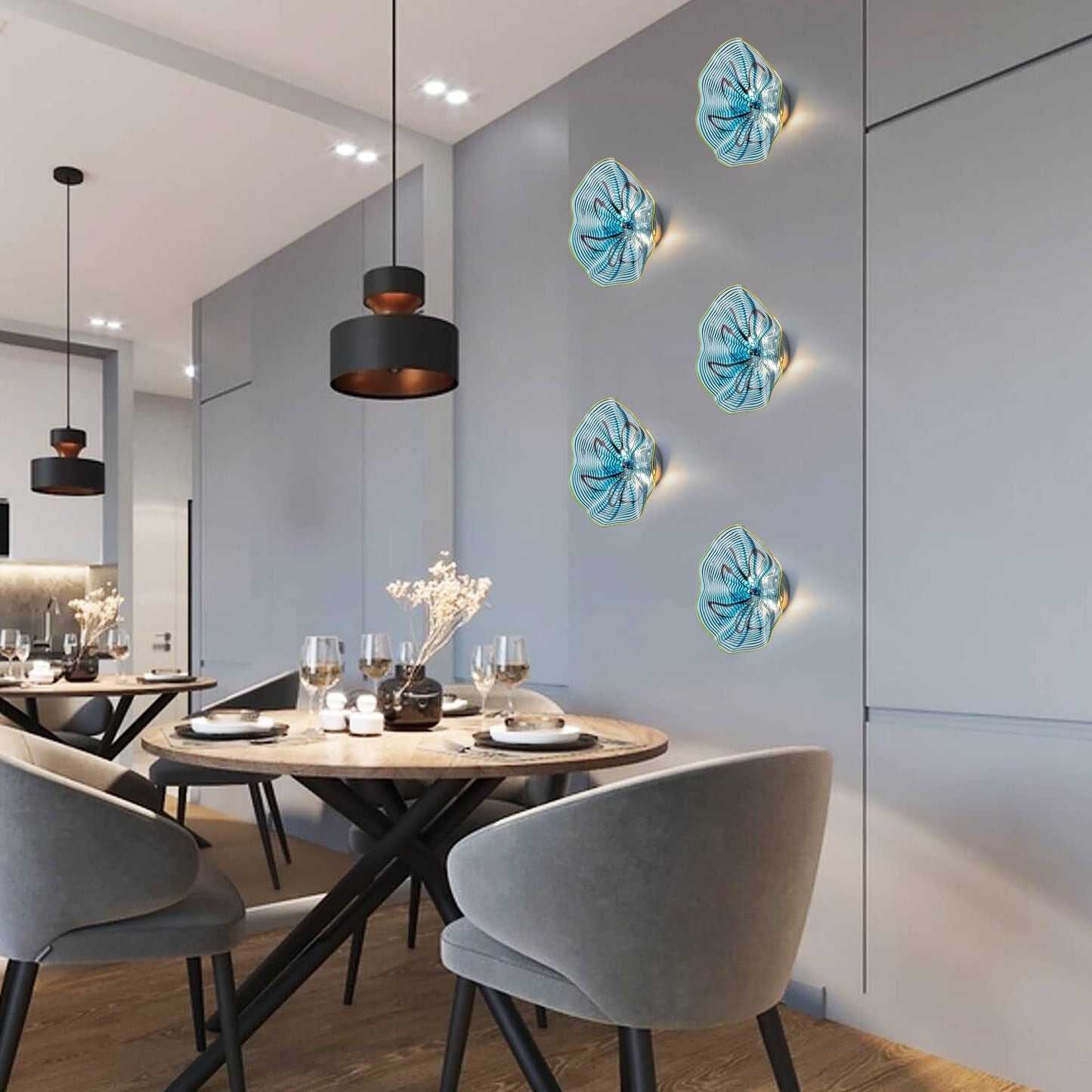 Abstract arrangement of four aqua glass LED wall sconces in a contemporary dining room with dark accents.