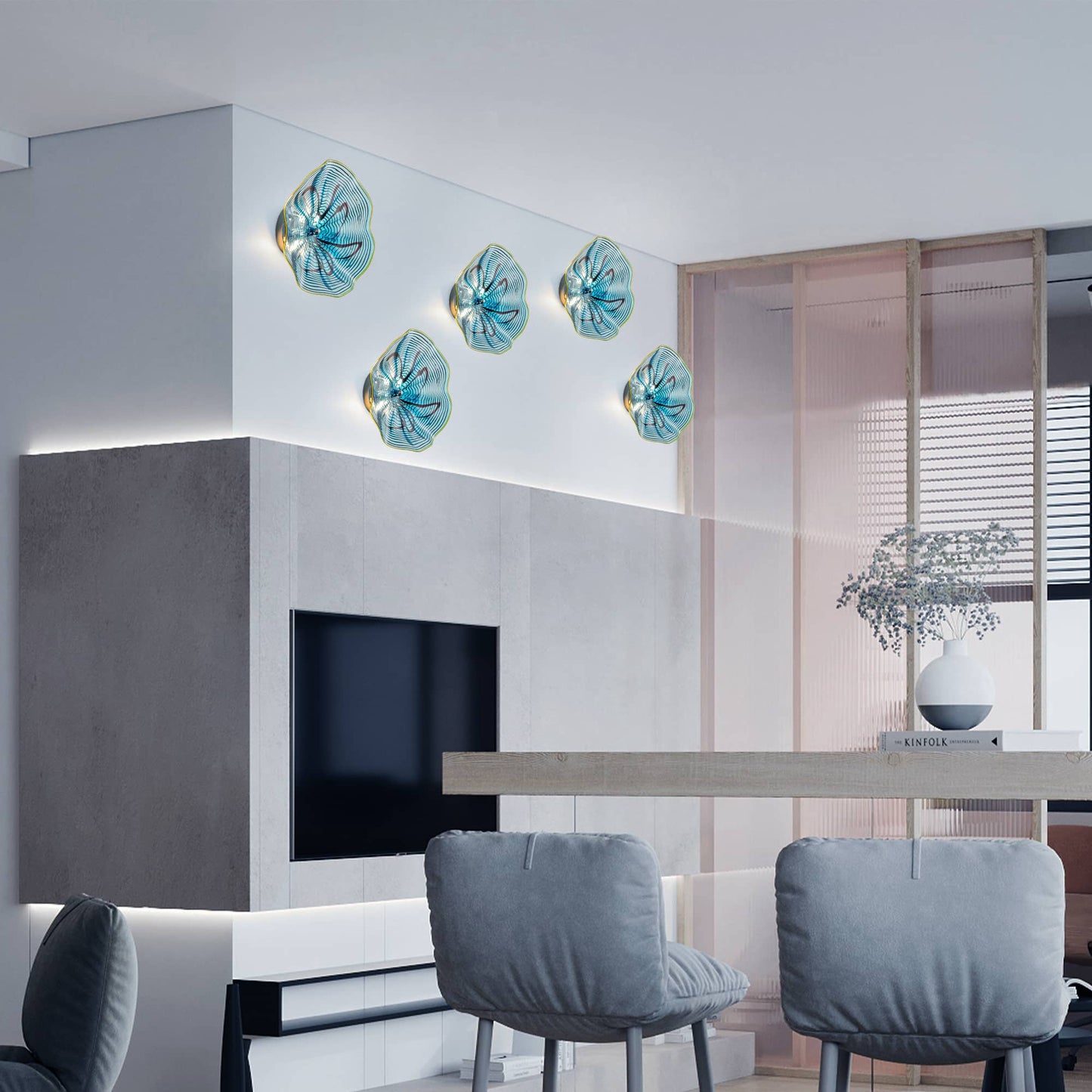 Symmetrical display of glowing aqua glass art lights framing a television in a minimalist living room.