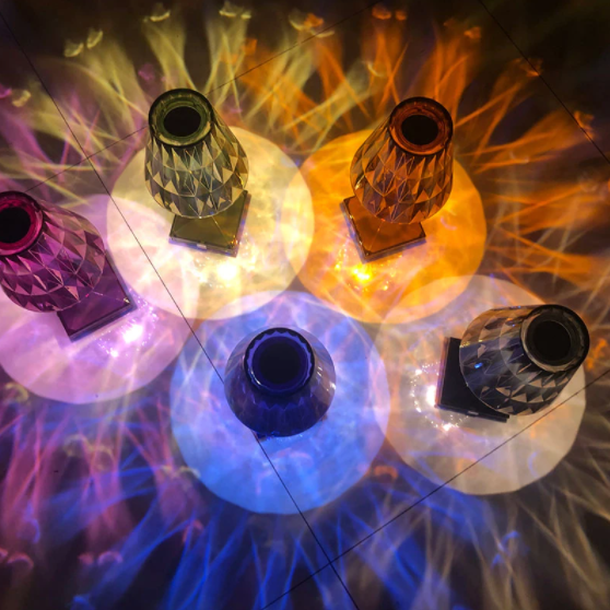 Colorful rechargeable crystal lamps in purple, blue, and amber for bedside atmosphere.