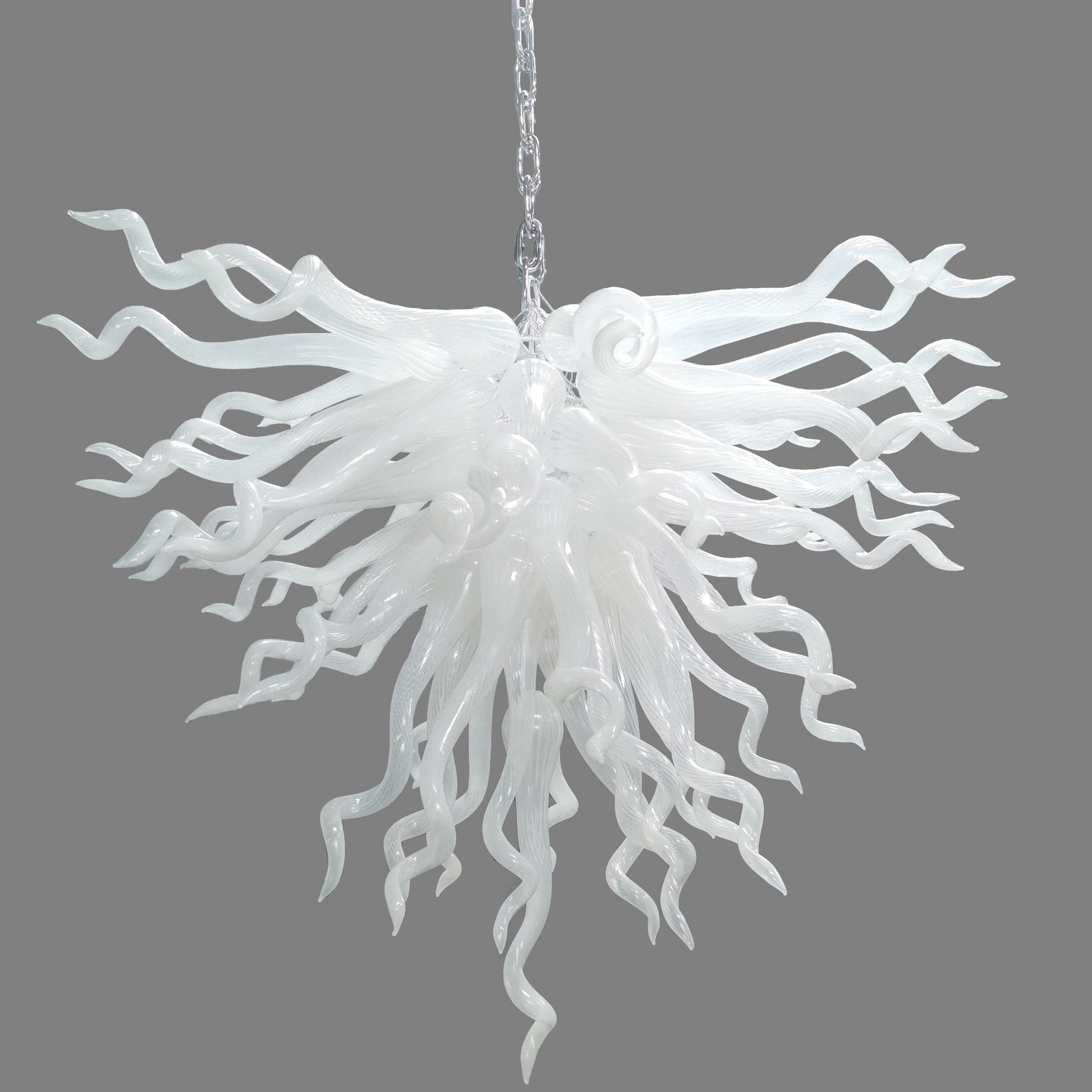 Serene Waterfall artisan glass chandelier featuring a dense cluster of hand-blown white glass spirals hanging from a metal chain