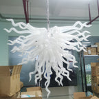 Serene Waterfall artisan glass chandelier featuring a dense cluster of hand-blown white glass spirals hanging from a metal chain
