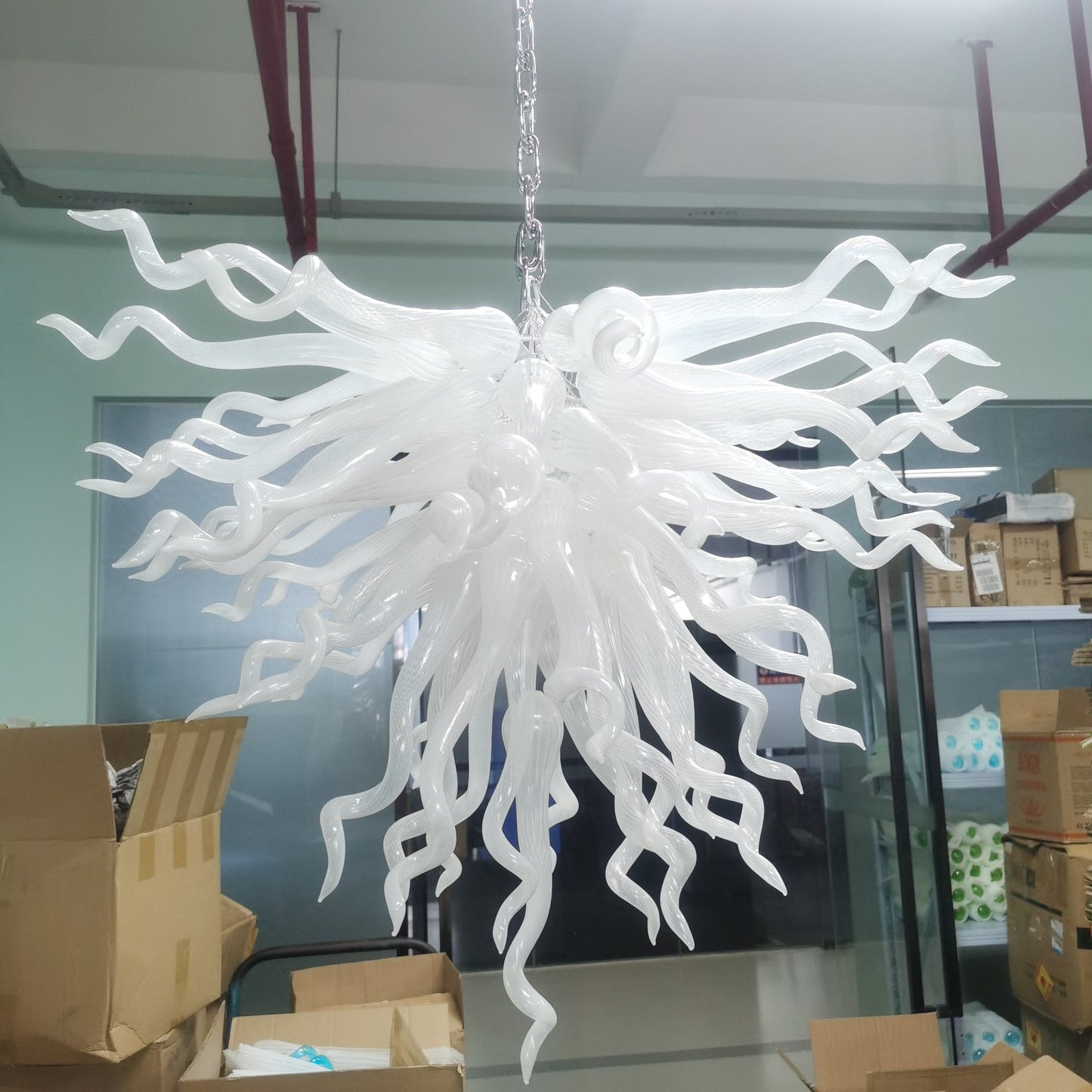 Serene Waterfall artisan glass chandelier featuring a dense cluster of hand-blown white glass spirals hanging from a metal chain