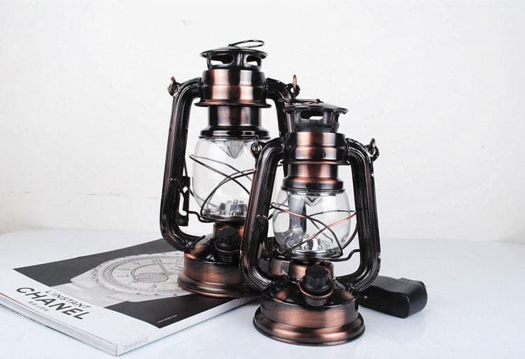 Minimalist black metal vintage LED lantern with adjustable handle for hanging.