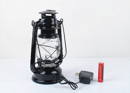 Modern black vintage LED lantern with rechargeable battery and charging cable.