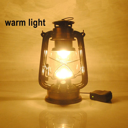 Portable vintage camping lantern emitting warm yellow light for cozy outdoor ambiance.